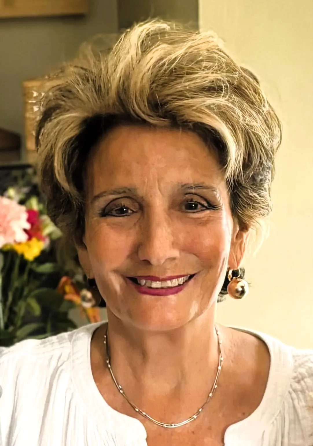 A woman with short hair smiles for the camera.